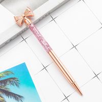 Wholesale New Arrived Custom Logo Engraving Bowknot Head Glitter Floating Metal Pen Novelty D Cuticle Oil Floated Liquid Pen with Bowknot Top