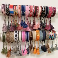 Wholesale Luxury style rope material woven bracelet with sewing words and tassel hand strap brand jewelry for women gift