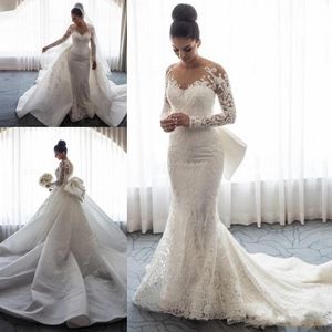 2021 Vestidos de novia de sirena de lujo Cuello transparente Manga larga Ilusión Apliques de encaje completo Arco Faldas con botones Volver Capilla Tren Vestidos de novia