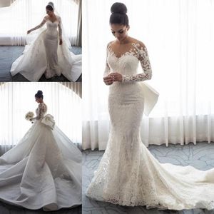 Nieuwe Luxe Mermaid Trouwjurken Sheer Neck Lange Mouwen Illusie Full Lace Applique Bow Overskirts Button Back Chapel Train Bridal Towns