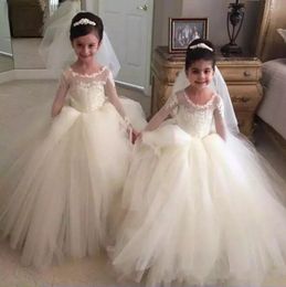 2020 Vestidos de desfile de tul blanco para niñas con cuello de joya transparente Apliques de encaje Ilusión Vestido de fiesta de manga larga para niños Vestido de niña de ropa formal