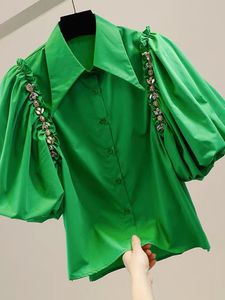2023 Nouveau automne pour femmes d'été Blousses Fashion Puff Sleeve Diamond Inralide Chain Decoration Irréguled Single Gwirted Shirt Top