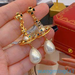 2024 Designer Luxury Xitai Queenjewellery Silver Needle Fashion Commuter Swallow Pearl Long Solid Earth Planet Color Zirconia Moules d'oreilles