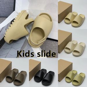 2024 Pantouflue Big Baby Slide Sandales Sandales Solides Solide Chaussures pour enfants Clog Sandale Acoustique Eva Black Gris Boys Filles Tainers Tainers Designer Beach Sandals Shoe