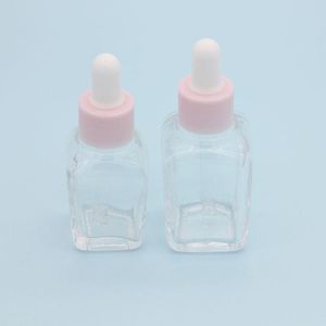 Flacon compte-gouttes carré d'huile essentielle de 20 ml, flacons de sérum en verre transparent de 30 ml avec bouchon rose pour cosmétiques Fjgjx