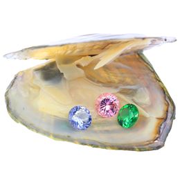 Three 8mm8mm loose round cubic zircons of different color are displayed in vacuum-packed oysters