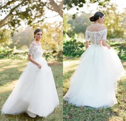 2020 New Modest Country Lace Wedding Dresses Cheap Off Shoulder Short Sleeves Simple White Tulle A Line Beach Covered Buttons Bridal Gowns