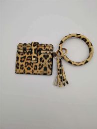 Multifunctional Accessory: This leopard print bangle bracelet doubles as a wallet, keychain, and wristlet, offering convenience and style in one.DA537