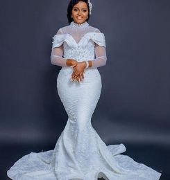 Plus Size African Mermaid Wedding Dresses 2022 Illusion Long Sleeve High Neck Pearls Lace Floral Aso Ebi Arabic fishtail bridal gowns