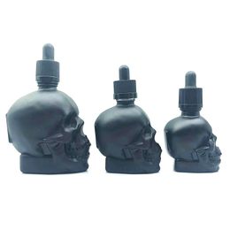 Empty 30ml 60ml Skull Shaped Glass Cosmetic Essential Oil Bottle with Black Childproof Cap Matte Black Skull Tincture Oil Bottle Wholesale