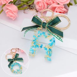 Fashion 26 Letters Resin Keychains for Women Gold Foil Christmas Bowknot Bag Pendant Charms Handbag Accessories Tassel Key Rings