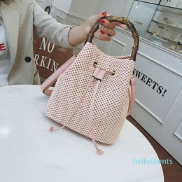 Two-color bamboo is suitable for travel luxury designer bags. Simple style Joker handbag barrel-shaped hand-woven diagonal shoulder