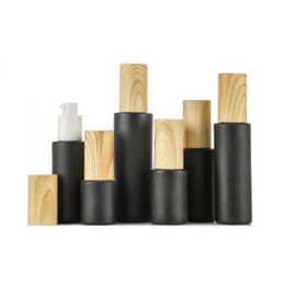 Empty glass pump bottles refillable black frosted lotion essential oil spray with woodgrain plastic cap 20ml - 80ml k28