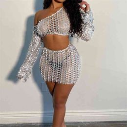 OMSJ Sexy Hollow Out Two Piece Set Women's Club Outfits Silver Off-shoulder Long Sleeve Crop Top And Mini Skirt See-through Suit 210517