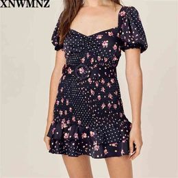 Women Floral and dot print smocked mini dress featuring puff sleeves tonal belt. Playful tiered ruffle hem. 210520