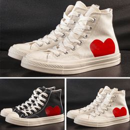 white sneakers with red heart and eyes