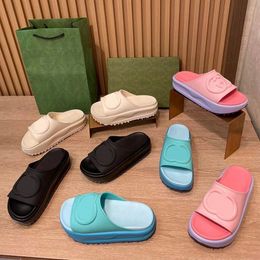 Mens Interlocking slide sandal Influenced by the 70s brands iconic era archival design embossed detailing appears on these black rubber designer sandals