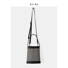 Bag female 2021 Korean version new fashion messenger bag versatile ins niche design straw woven splicing hand