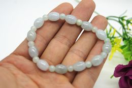 Natural white jade. 12 drum beads +12 round beads. Rubber bands are strung together into bracelets.