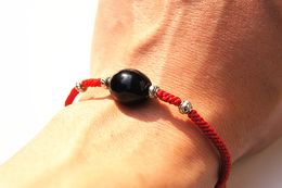 Hand catenary, pure manual weaving Hong Kong red knot + black drum agate beads + Tibetan silver beads bracelet.