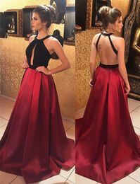 2018 Unique Designer Red Black Evening Prom Dress Long A line Satin Open Back Halter Pleated Cheap Red Celebrity Pageant Formal Dress Long