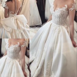 Classic Romance Satin Bridal Dress Sheer Jewel Short Sleeves Lace Applique Big Bow Wedding Dresses Sexy See Through Backless Wedding Gown