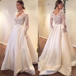 2018 Sheer Long Sleeve V-neck Lace Wedding Dresses A-line With Pocket Satin Skirt See Though Back Bridal Party Dress Wedding Gowns