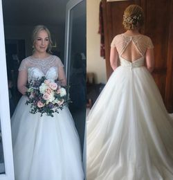 2020 Modest Elegant Ball Gown Short Sleeve Hollow Wedding Dresses Tulle Lace Beads Wedding Gowns Sweep Train Jewel Neck Bridal Gowns