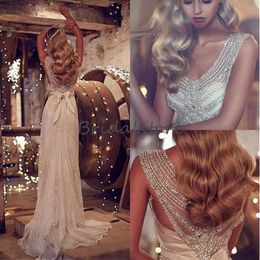 Abiti da sposa da spiaggia con perline svasate svasate scollo a V profondo senza maniche abiti da sposa modesti bohémien con fiocco bellissimo pizzo 2019 robe de mari￩e