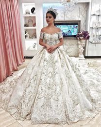 2020 New Dubai Arabic Luxury Sparkly Ivory Wedding Dresses Sexy Bling Beaded Lace Applique Illusion Long Sleeves A Line Chapel Bridal Gowns