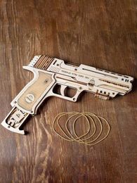 Free shipping The New Ukraine Wooden mechanical transmission Model toys Bursts Rubber band Pistol toy Children's assembly
