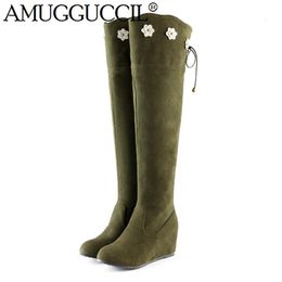 green rubber boots with yellow laces