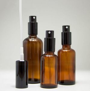 Toppförsäljning 30 ml 50 ml 100 ml Portabel Amber Glass Essential Oil Spray -flaskor Tom påfyllningsbar parfym Atomizer med svart mössa