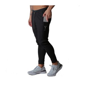 Joggers Sport Mens byxor Sidofickor Elasticitet Sweatpants Bomull Män Fitnessbyxor Ropa Hombre Mode Skinny Casual Pants LJ201103