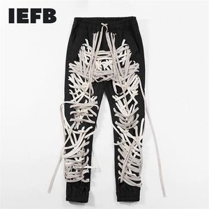 IEFB /herrkläder high street Patchworksnören Bandage mansbyxa Hög midja Casual Slim Byxor Streetwear Mode Tide 210317