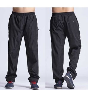 Mäns sommar Snabbtorkad andningsbara tunna byxor Elastiska midja Sportkläder Sweatpants Outdoors Motion Joggar Män Zipper Byxor Y0816