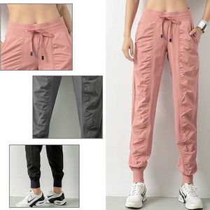 Tyg Drawstring Running Sport Joggers Kvinnor Snabbtorkat Atletisk Gym Fitness Sweatpants med två sidofickor Övning Byxor Y0811