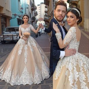 2021 Champagne Arabic Gorgeous Ball Gown Wedding Dresses White Lace Appliques Scoop Neck Crystal Beads Long Sleeves Sweep Train Puffy Tulle Open Back Bridal Gowns