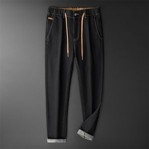 Tfetters outono inverno moda calça jeans homens espessos de algodão macio elástico cintura solta jeans zíper cordão design namorado jeans 211011