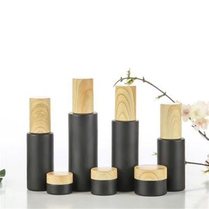 Black Frosted Glass Cosmetic Bottle Cream Jars Spray Lotion Pump Bottles Refillable Container with Wood Grain Plastic Lids