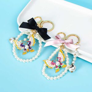 XDPQQ Europe and America Creative New Rhinestone Butterfly Pendant Pearl Bow Knot Keychain Girls Bag Accessories G1019