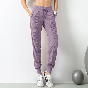 Roupa de ioga 2021 Calça de moletom de ginástica com cordão de tecido e cordão para corrida feminina de secagem rápida para academia com dois bolsos laterais