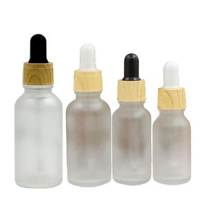 空の白い霜のガラスの滴ボトルの偽の木製のプラスチック襟の蓋5ml 10ml 15ml 20ml 30ml 50ml 100ml化粧品包装のエッセンシャルオイルバイアルの詰め替え可能な容器