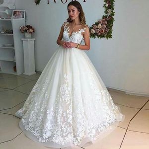 2022 Abiti da sposa in pizzo bianco / avorio Appliques senza maniche Abiti da sposa Top Scollo trasparente Lunghezza del pavimento