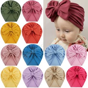 Bowknot Hood Cappello indiano annodato per bambini Cappello di gomma neonato Pieghe a tinta unita Cappello a ciambella Regalo di compleanno Puntelli per foto