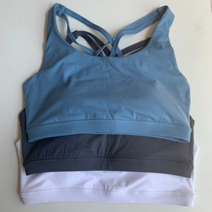Mode Designer Yoga Kläder Energi Kvinnor Sport Underkläder Kors Bra Sexig Silikon Bottun Pad