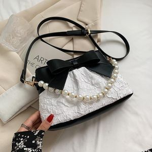 Sacos de noite de luxo de luxo Balde de renda com laço para mulheres 2021 feminino moda pérola cadeia de cor sólida bolsas e bolsas