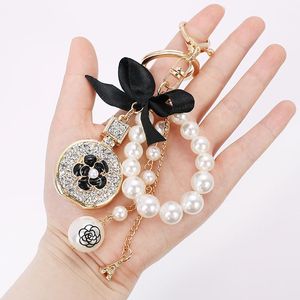 Keychains Bow Knot Imitation Pearl Perfume Crystal Bottle Iron Tower Chain Keychain Car Key Ring Bag Charm Accessories Girl Keyring Gift
