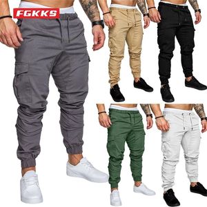 Fgkks masculino calças mens corredores sólidos multi-bolso calça calça de moletom homens hip hop harem 220325