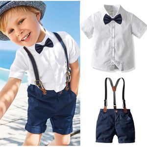 Boy Bow Gentleman Clothes Camicia bianca Pantaloncini blu scuro con bretelle Bambini Abiti da vacanza per bambini Set manica corta 220620